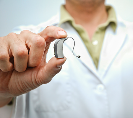 Image of doctor holding hearing aid